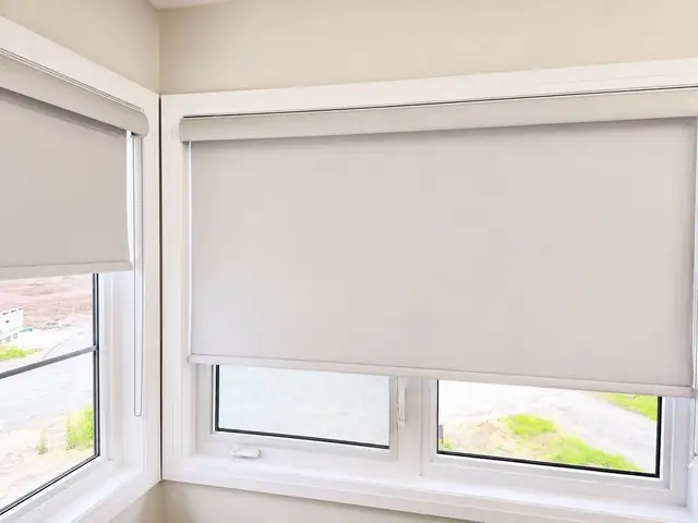 Roller shades fitted to both sides of a corner window